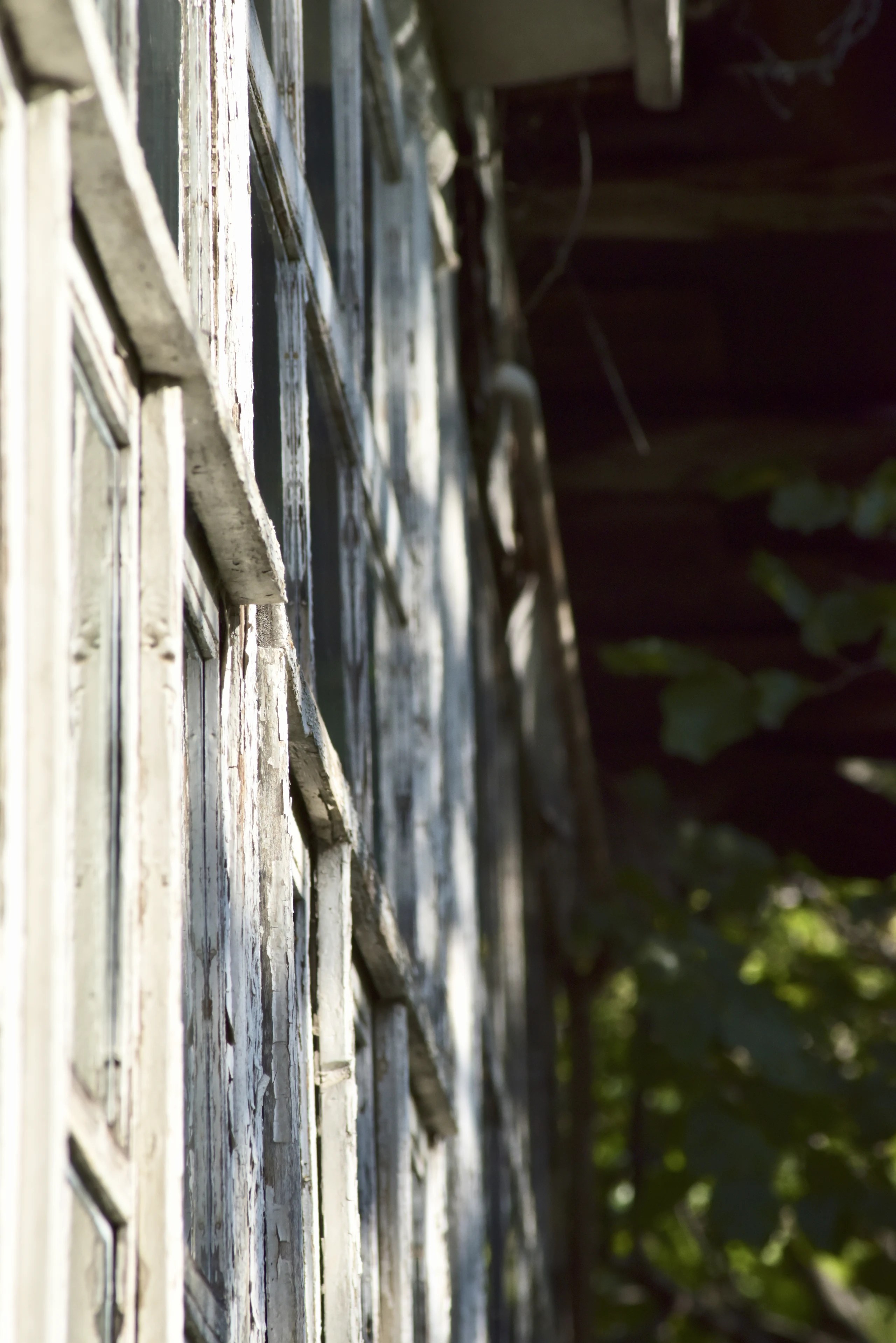 Close view of peeling wooden windows on an old building in Kapan.